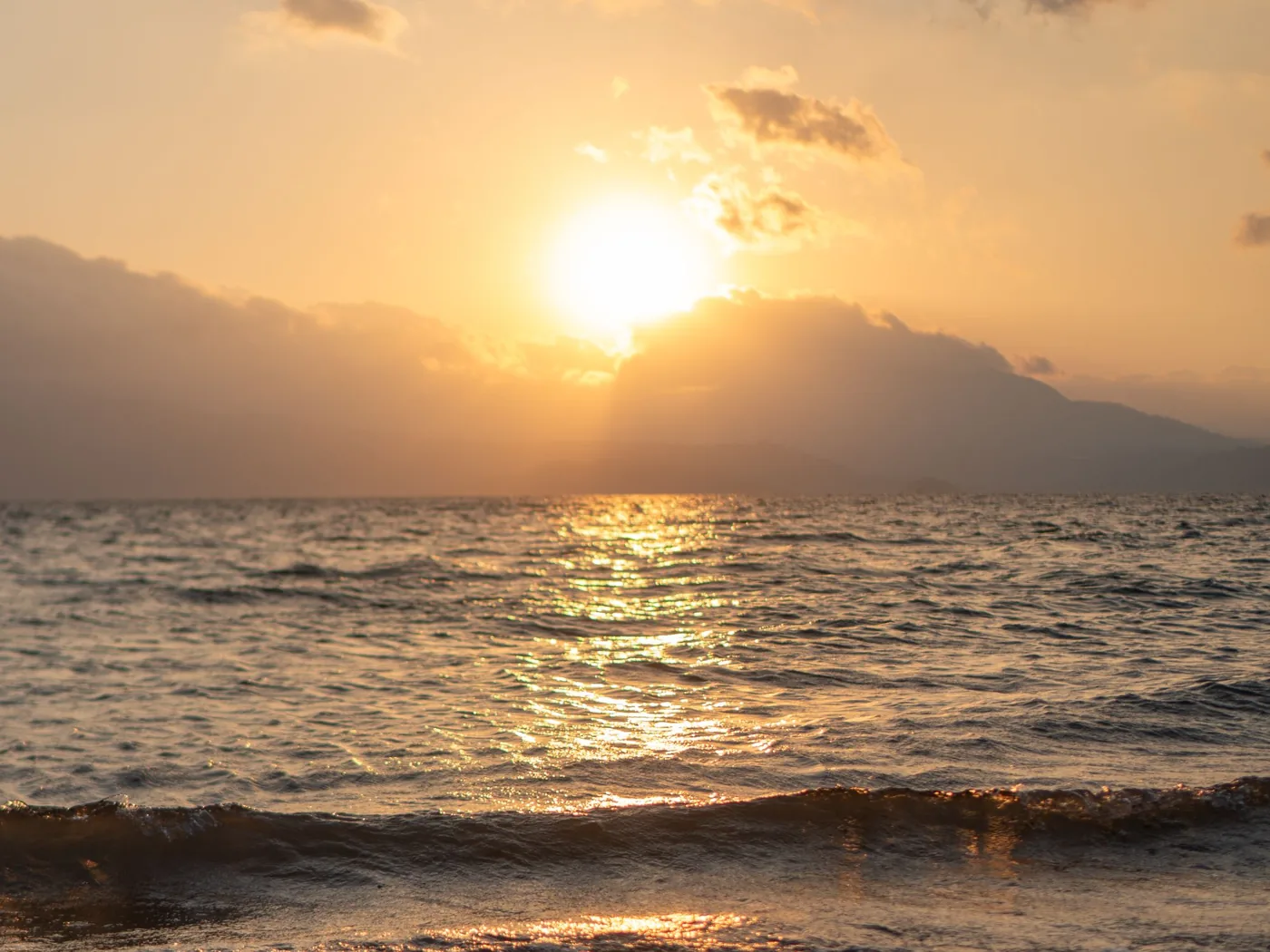 Sunset over the Pacific on the coast of El Salvador, with mountains on the horizon